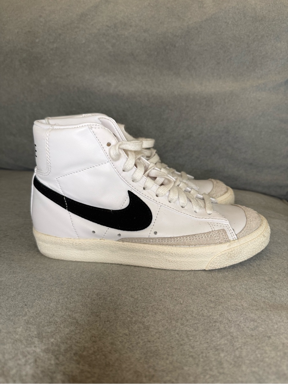 Nike White High-Top Sneakers with Black Swoosh